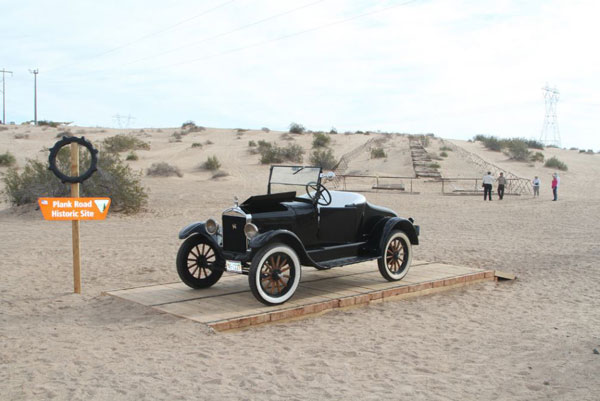 Vintage Model T car displayed on a reconstructed section of the historic Plank Road in the Imperial Sand Dunes near Yuma, Arizona.