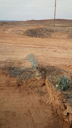 Aerial view of uncovered drainage pipe section Aerial view of uncovered drainage pipe section