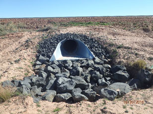 Large rocks surround drainage pipe Large rocks surround drainage pipe