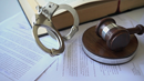 Dealer/Title Fraud Investigations Dealer/Title Fraud Investigations - Handcuffs, book and gavel on papers