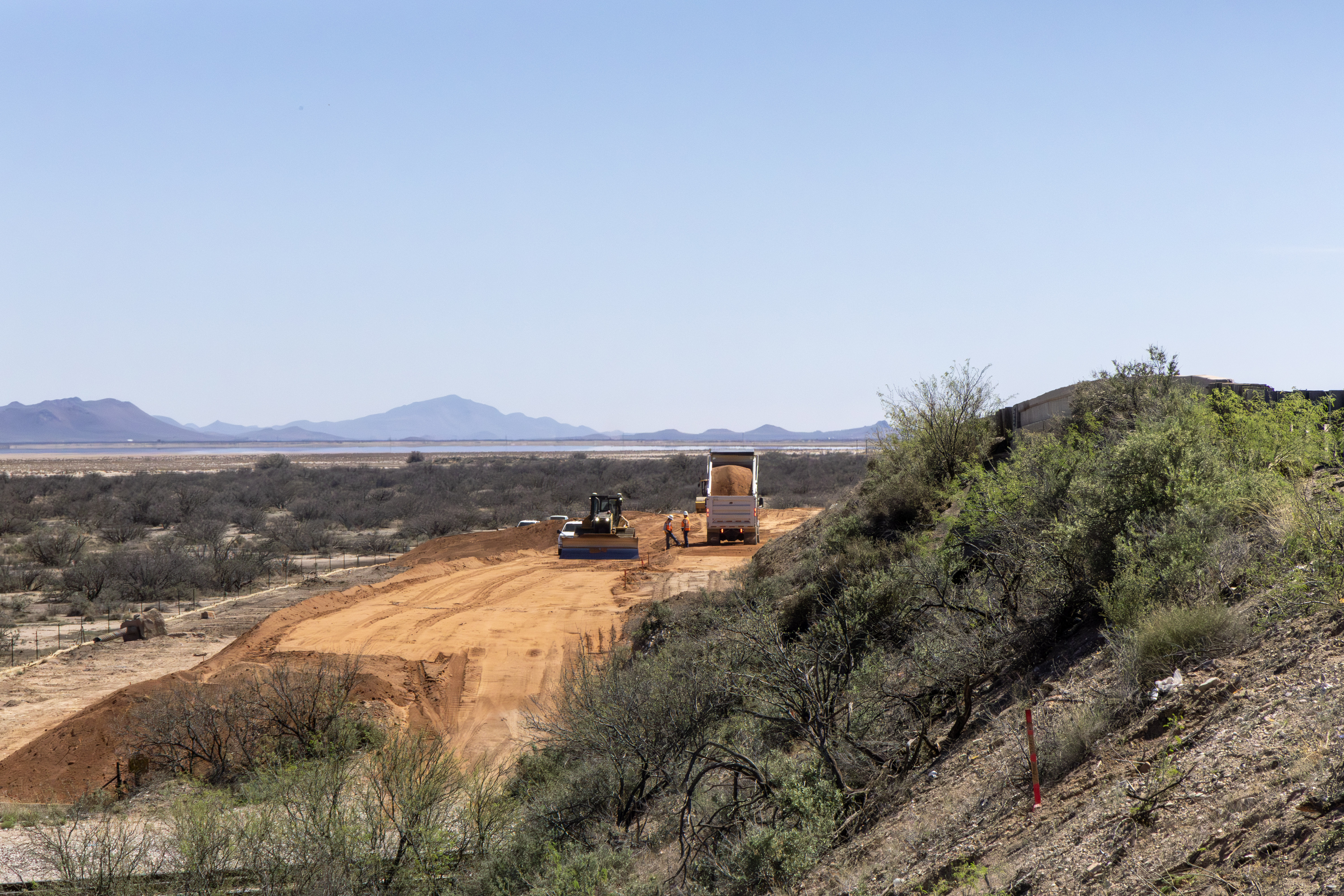 Construction equipment grading earth for the new US 191 Cochise railroad overpass bridge